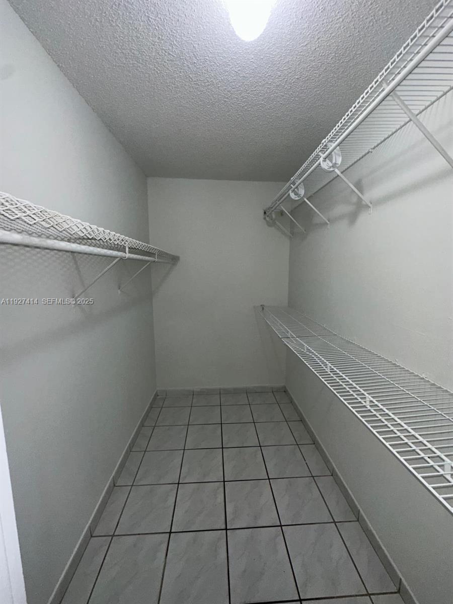 5665 West 20th Avenue, Unit 308 Hialeah, FL 33012 - Photo 13 of 17 a view of a room with racks on the wall