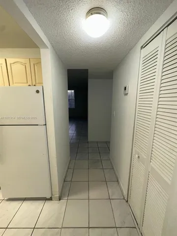 a view of a hallway to rooms and stairs