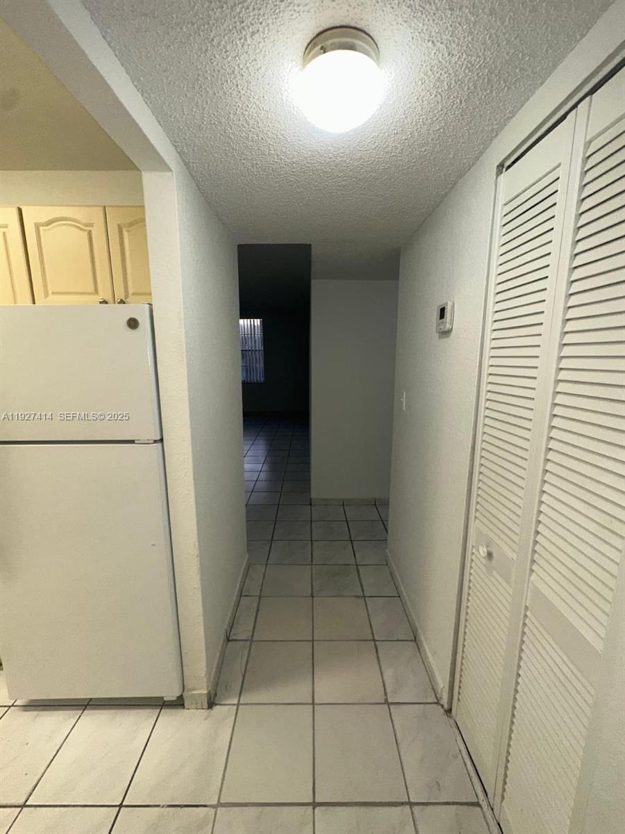 5665 West 20th Avenue, Unit 308 Hialeah, FL 33012 - Photo 2 of 17 a view of a hallway to rooms and stairs