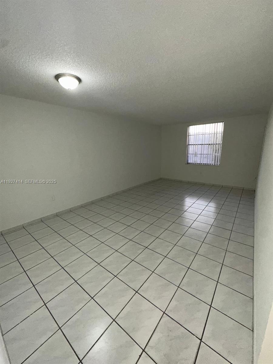 5665 West 20th Avenue, Unit 308 Hialeah, FL 33012 - Photo 5 of 17 an empty room with windows