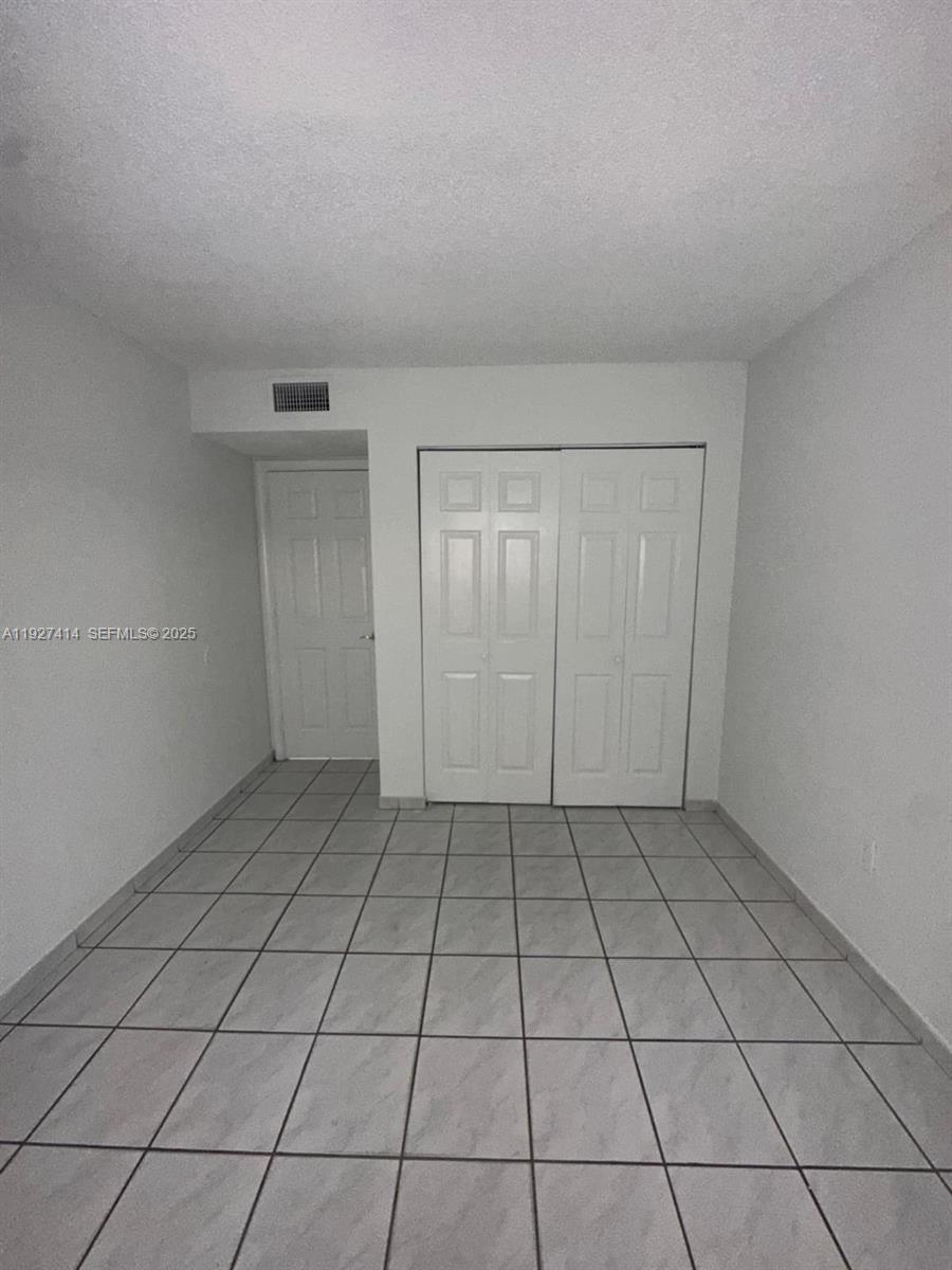 5665 West 20th Avenue, Unit 308 Hialeah, FL 33012 - Photo 10 of 17 a view of an empty room and window
