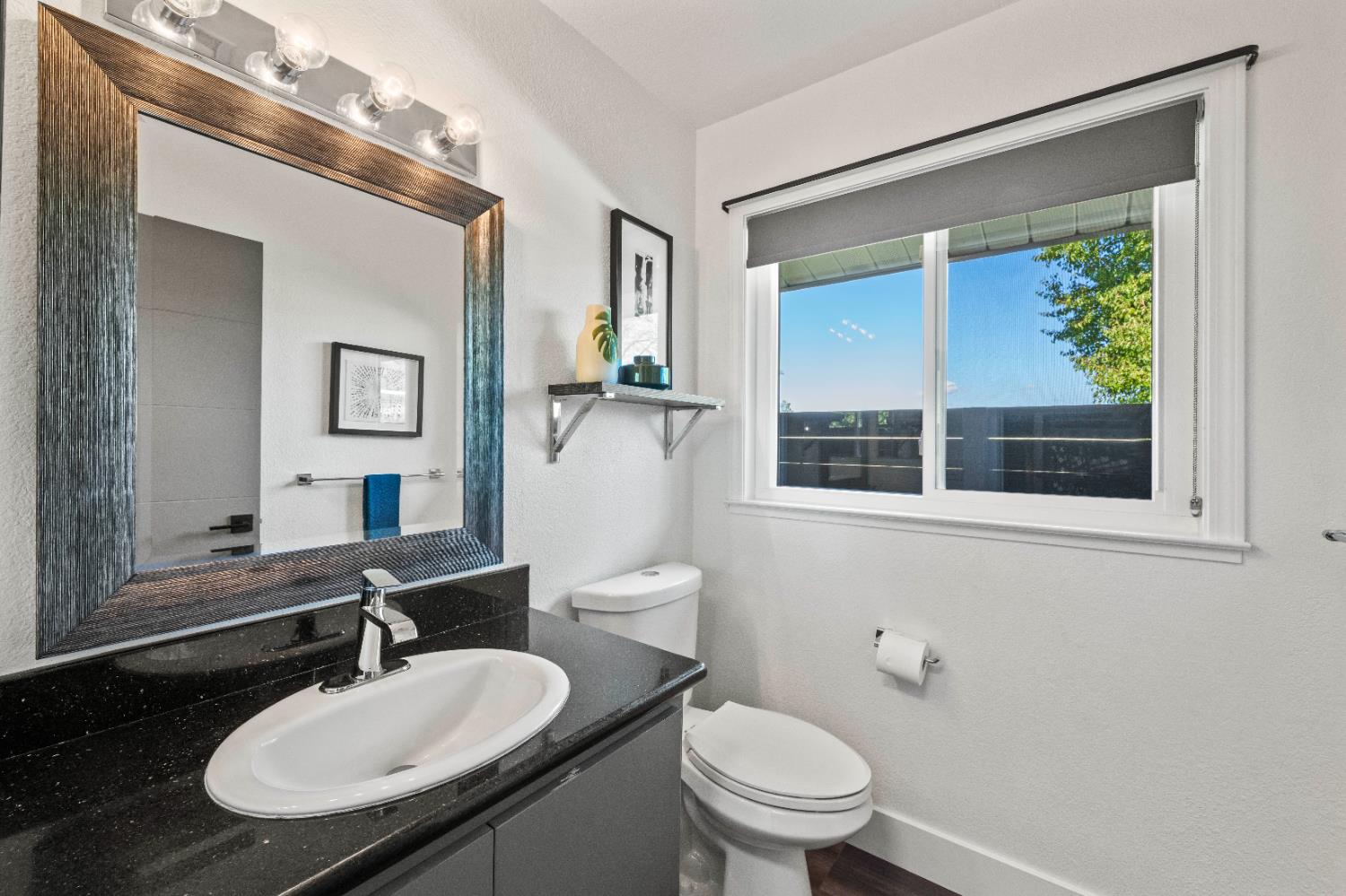 8155 Hubbard Road Auburn, CA 95602 - Photo 21 of 74 a bathroom with a granite countertop sink mirror a toilet and a window
