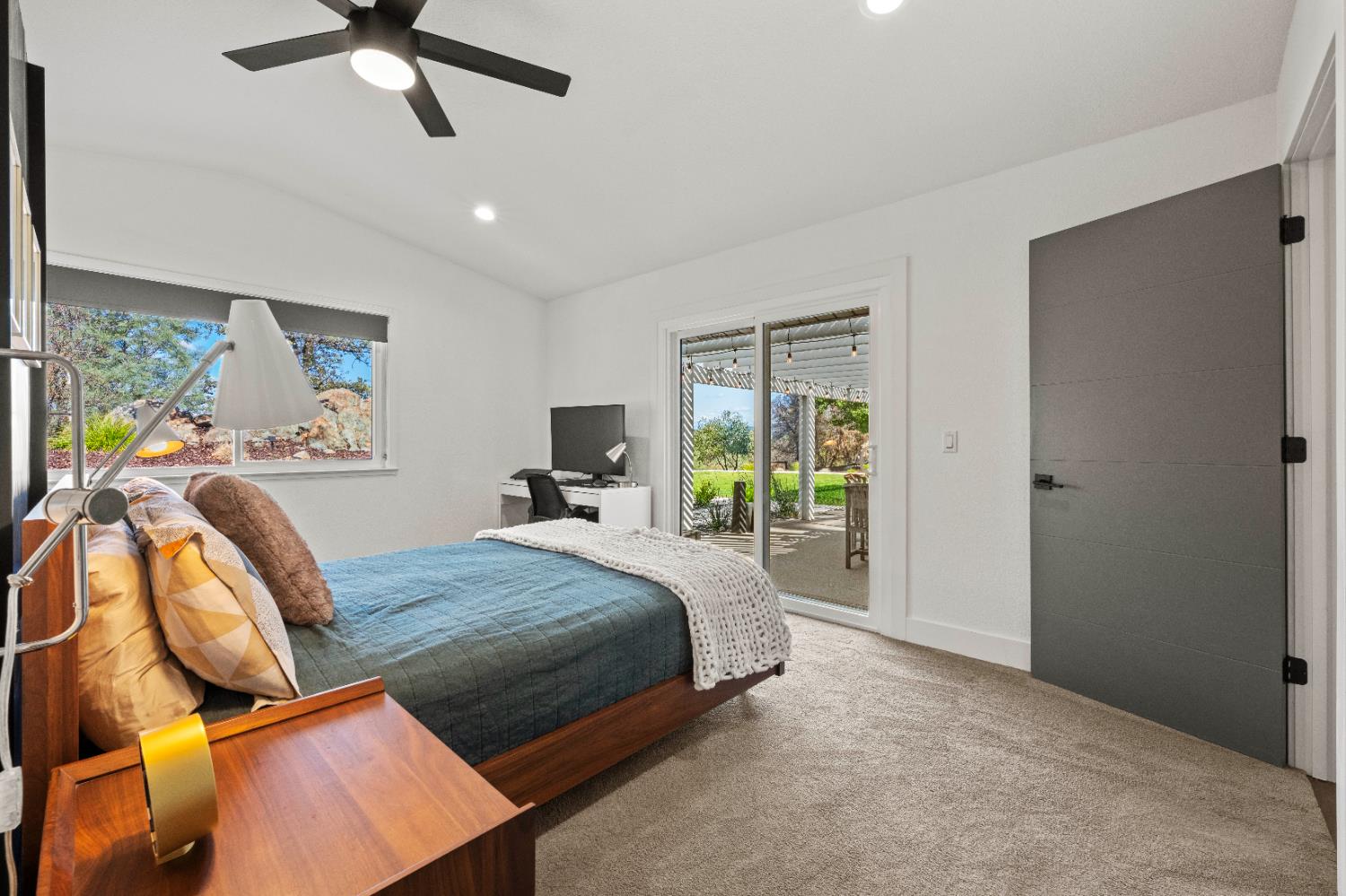 8155 Hubbard Road Auburn, CA 95602 - Photo 30 of 74 a bedroom with a bed ceiling fan and a window