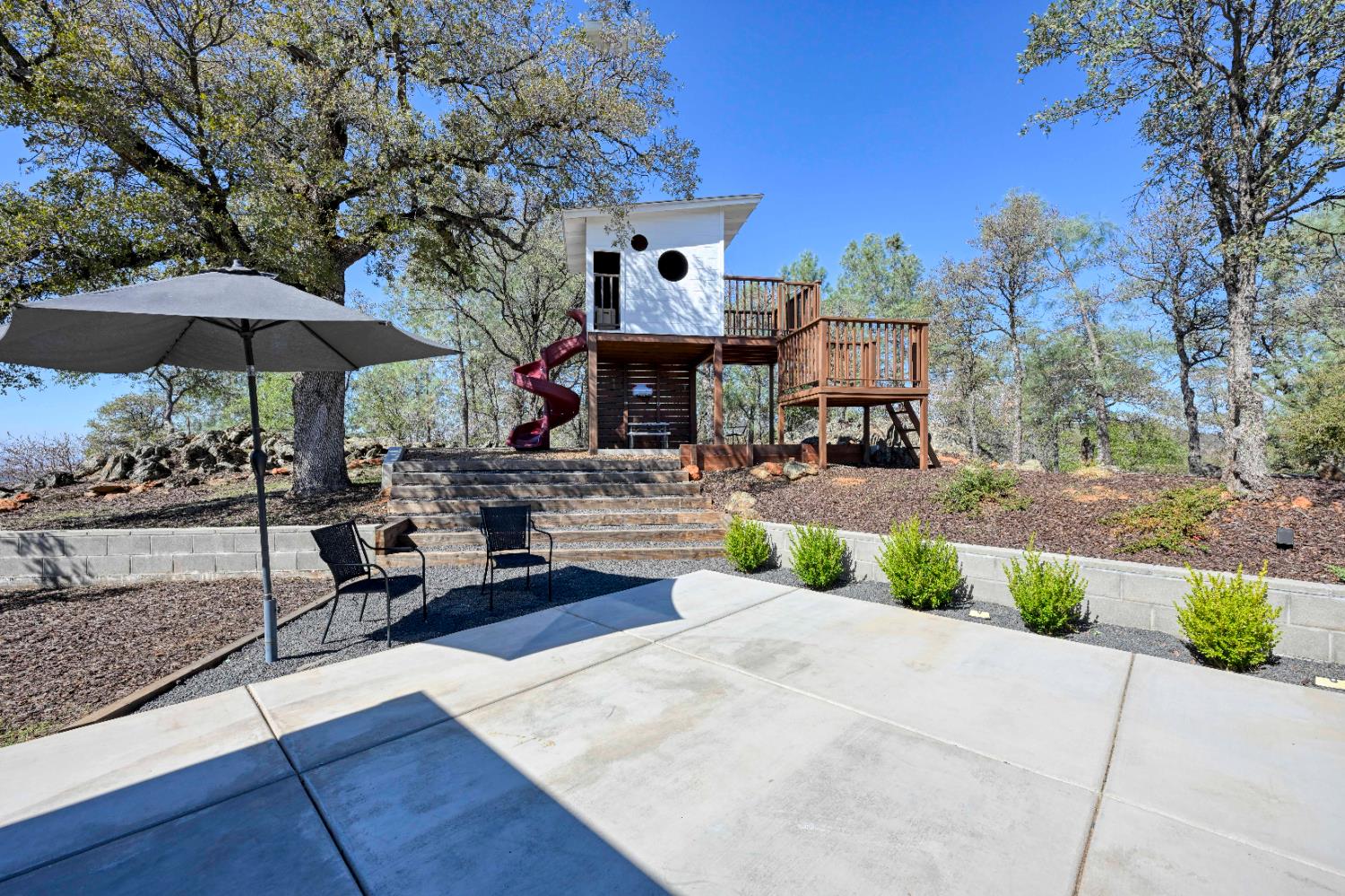 8155 Hubbard Road Auburn, CA 95602 - Photo 47 of 74 a front view of a house with garden and trees