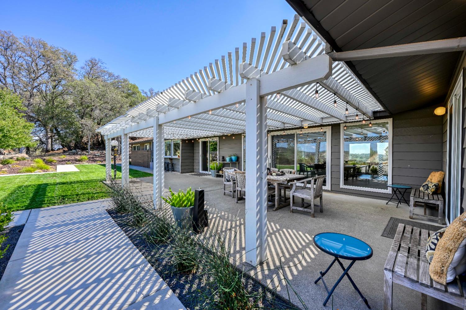 8155 Hubbard Road Auburn, CA 95602 - Photo 51 of 74 a view of patio with table and chairs potted plants and a big yard