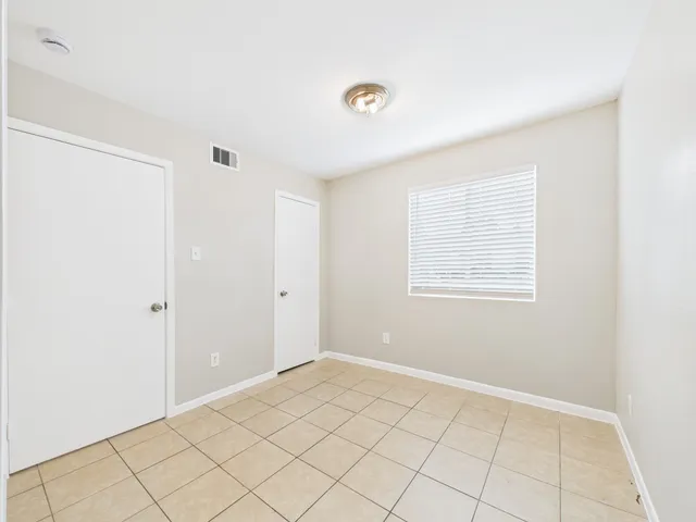 a bathroom with a toilet a sink a mirror and vanity