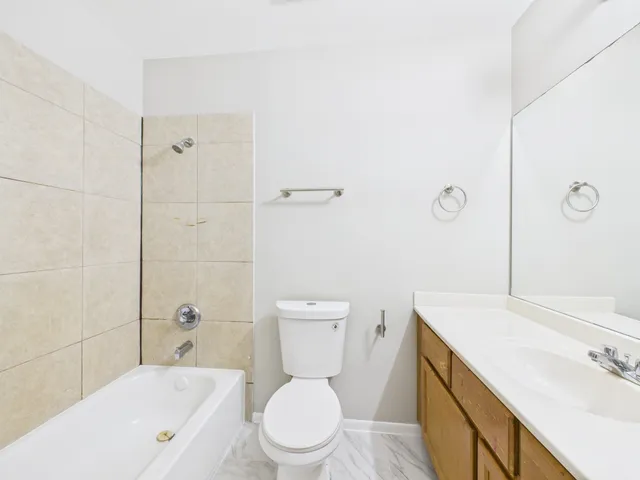 a white toilet sitting next to a bath tub
