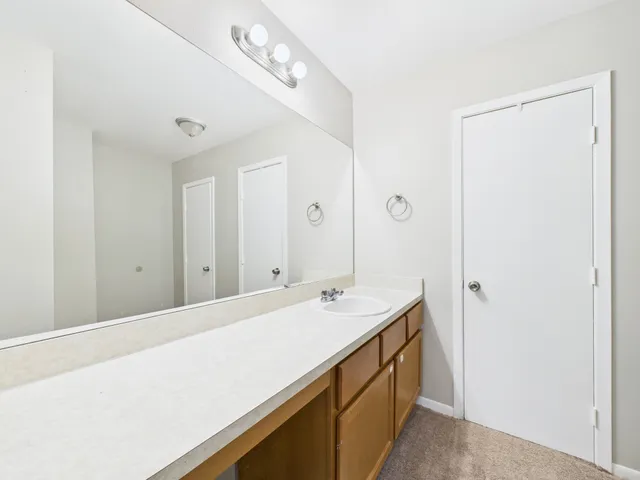 a spacious bathroom with a double vanity sink and a mirror