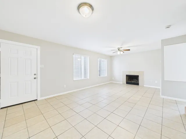 a view of an empty room with a fireplace