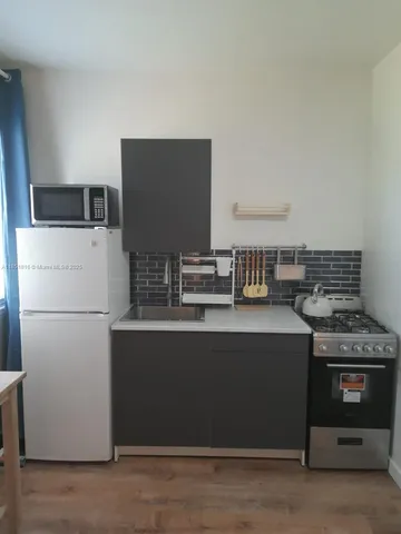 a kitchen with stainless steel appliances a stove and a refrigerator