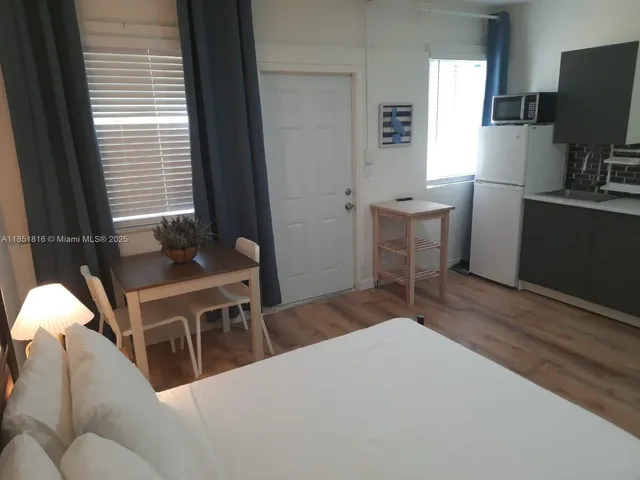 a bedroom with a bed and a desk in it