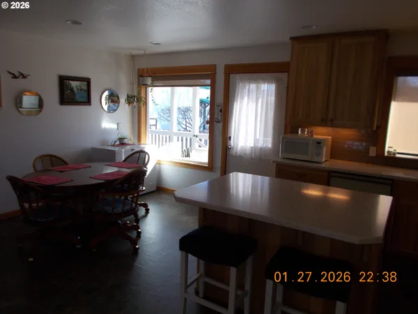 a view of a workspace room with furniture and window