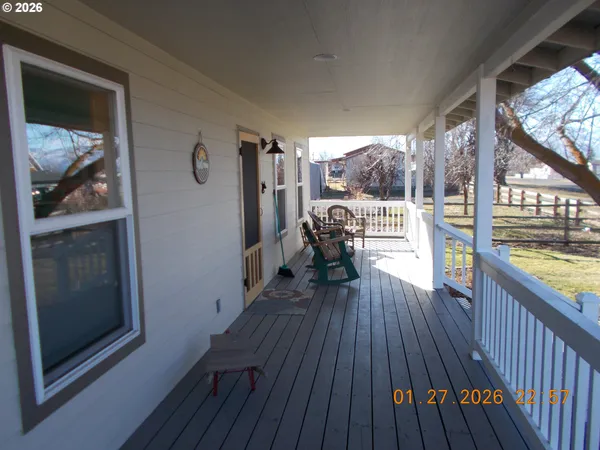 a view of a balcony with furniture and wooden floor
