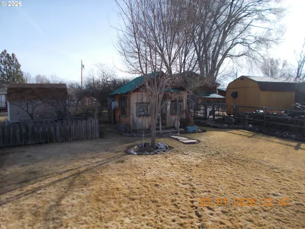 a backyard of a house with table and chairs