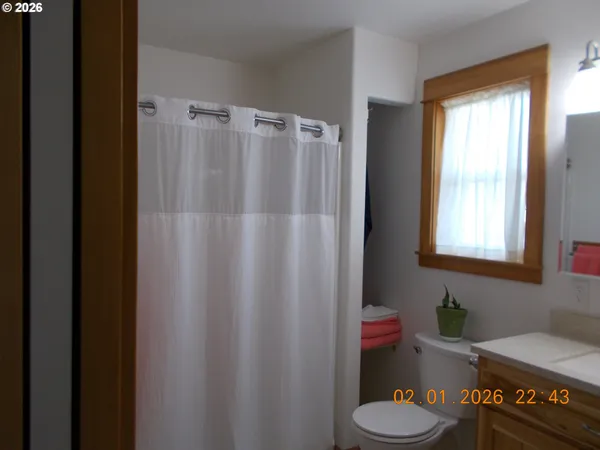 a bathroom with a toilet and a shower curtain