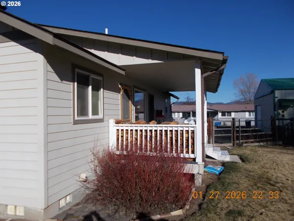 a view of a patio with a table and chairs