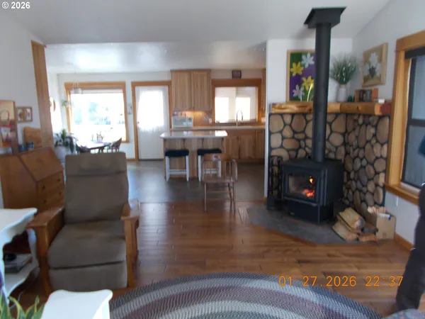 a living room with furniture a fireplace and a floor to ceiling window