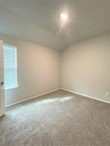 an empty room with a empty space and windows