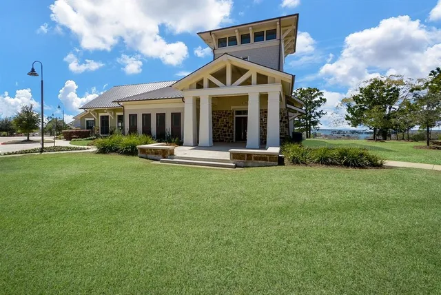 a front view of a house with a yard table and chairs