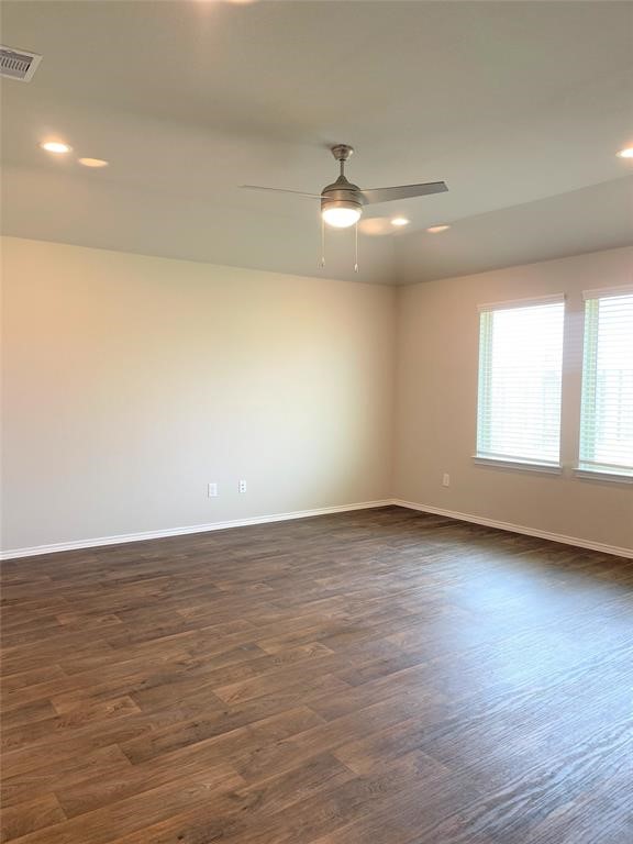 12118 Black Sage Court Conroe, TX 77304 - Photo 3 of 22 a view of an empty room with wooden floor and a window