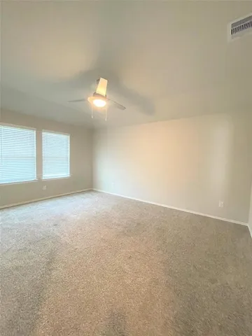 an empty room with a empty space and windows