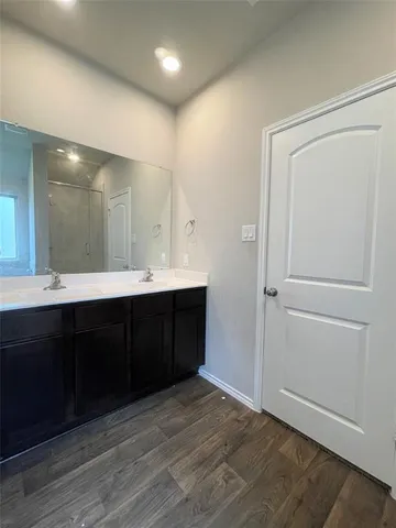 a bathroom with a double vanity sink and mirror