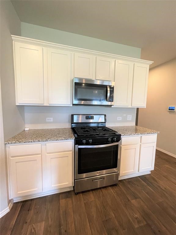 12118 Black Sage Court Conroe, TX 77304 - Photo 10 of 22 a kitchen with granite countertop wooden cabinets and a stove top oven