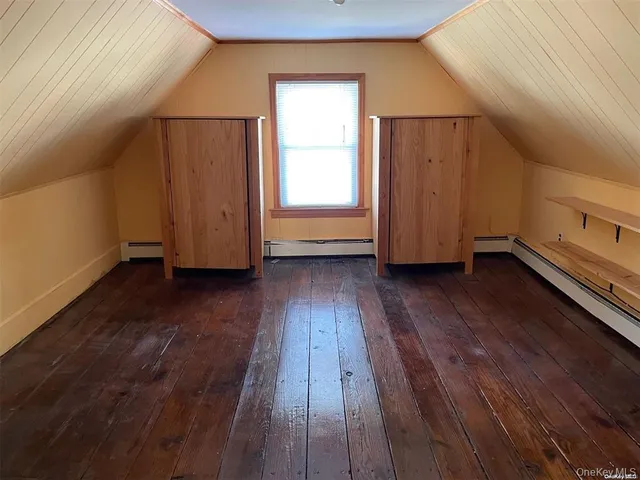 a view of a room with wooden floor and window