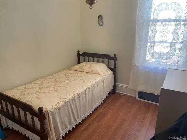 a bed sitting in a bedroom next to a window