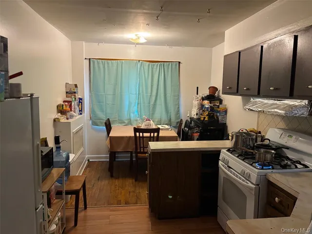 a kitchen with a table chairs stove and cabinets