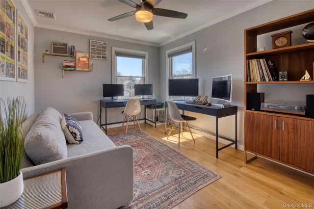 a work room with furniture wooden floor and a window