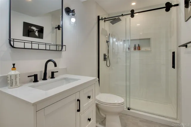 a bathroom with a sink toilet and shower