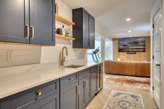 a kitchen with stainless steel appliances granite countertop a sink and a refrigerator