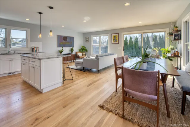 a living room with kitchen island furniture and a wooden floor