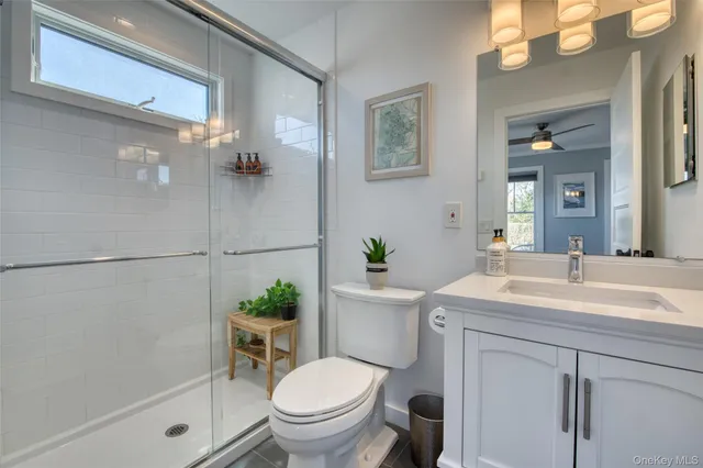 a bathroom with a sink toilet and a mirror