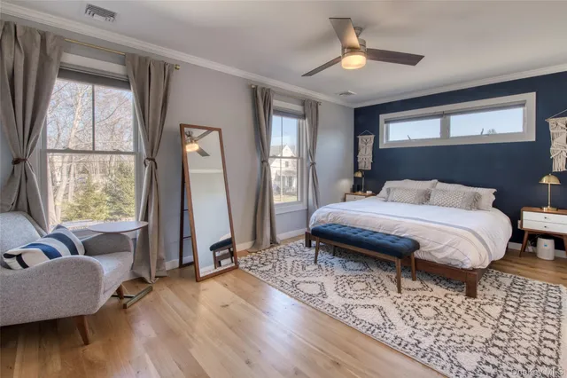 a bedroom with a bed couch and a window