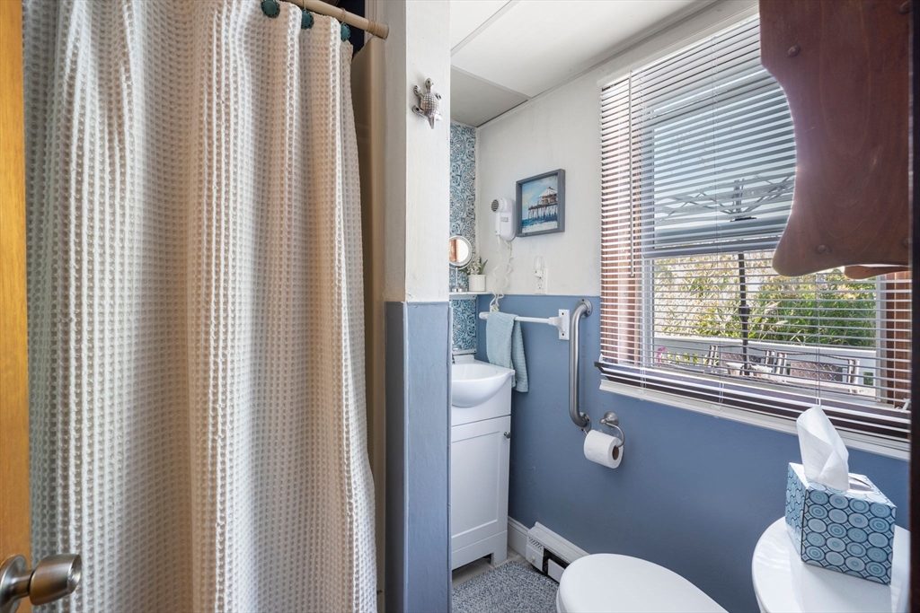 81 Constellation Road Marshfield, MA 02050 - Photo 12 of 42 a bathroom with a toilet a sink and a window