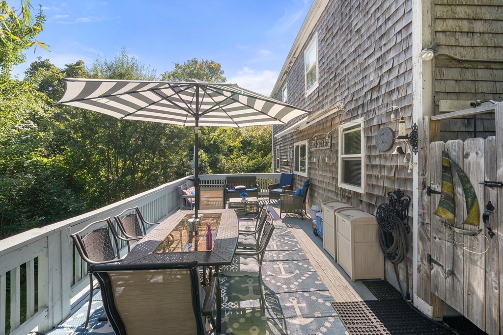 81 Constellation Road Marshfield, MA 02050 - Photo 26 of 42 a balcony with wooden floor table and chairs