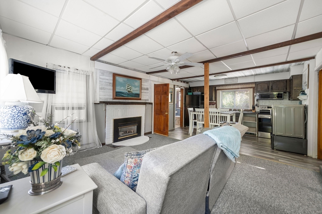 81 Constellation Road Marshfield, MA 02050 - Photo 3 of 42 a living room with furniture a fireplace and a flat screen tv