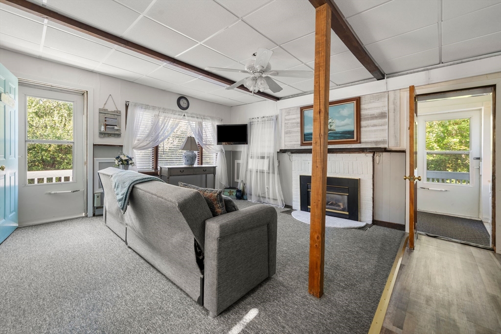 81 Constellation Road Marshfield, MA 02050 - Photo 4 of 42 a living room with furniture a fireplace and a large window