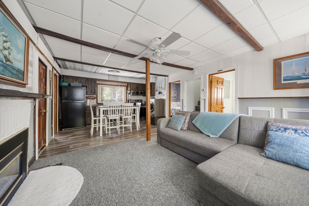 81 Constellation Road Marshfield, MA 02050 - Photo 6 of 42 a living room with furniture a fireplace and a ceiling fan