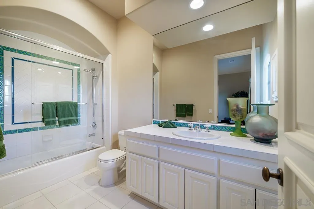 13752 Paseo Valle Alto Poway, CA 92064 - Photo 53 of 73 a bathroom with a toilet a sink and a large mirror