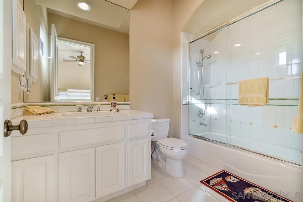 13752 Paseo Valle Alto Poway, CA 92064 - Photo 55 of 73 a bathroom with a double vanity sink a toilet and a mirror