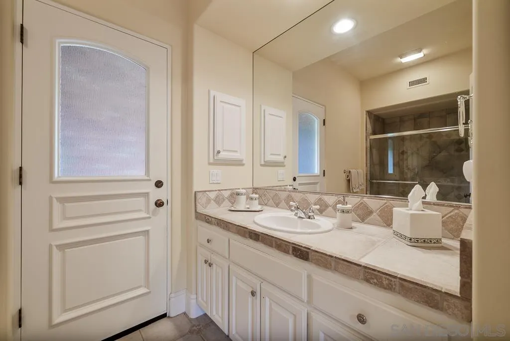 13752 Paseo Valle Alto Poway, CA 92064 - Photo 61 of 73 a bathroom with a sink and a mirror