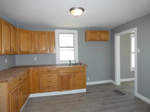 a kitchen with granite countertop a sink and cabinets