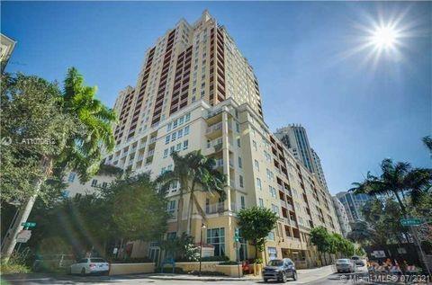 a view of a tall building next to a road