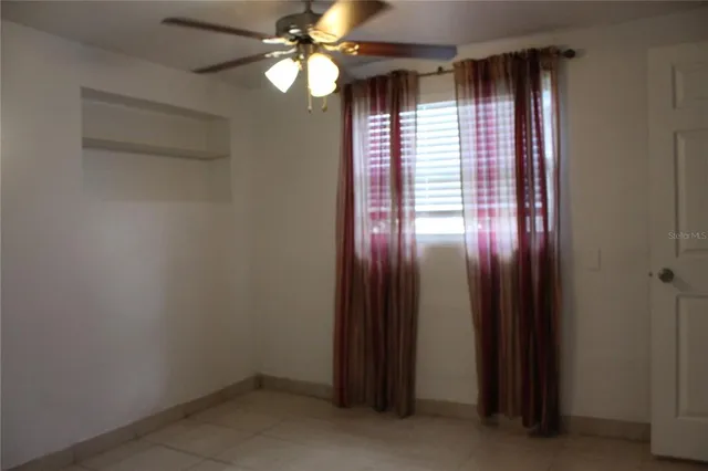 an empty room with windows and closet