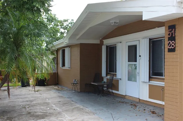 a backyard of a house with seating space