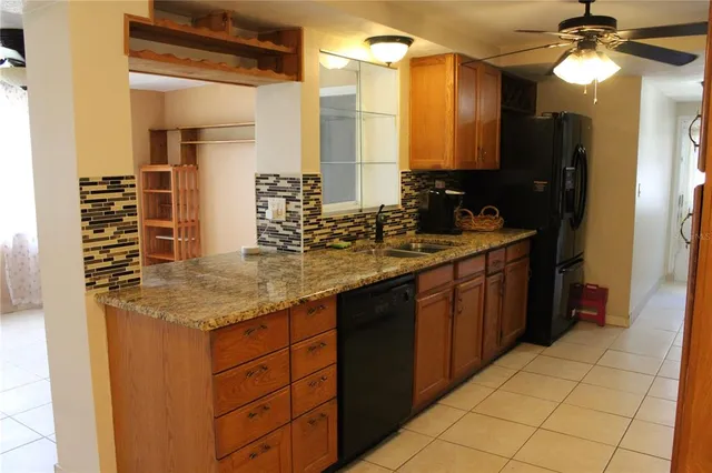 a bathroom with a granite countertop sink a mirror and a shower