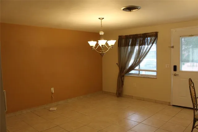 a view of a livingroom with a chandelier fan and furniture
